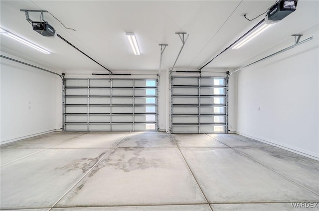 garage featuring baseboards and a garage door opener