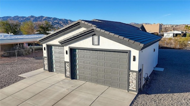 detached garage featuring a mountain view