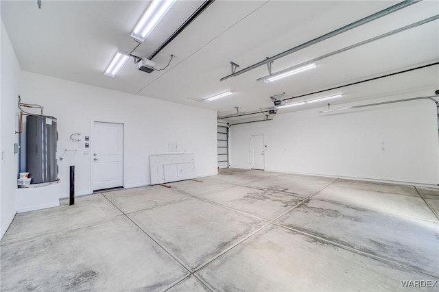 garage featuring electric water heater and a garage door opener