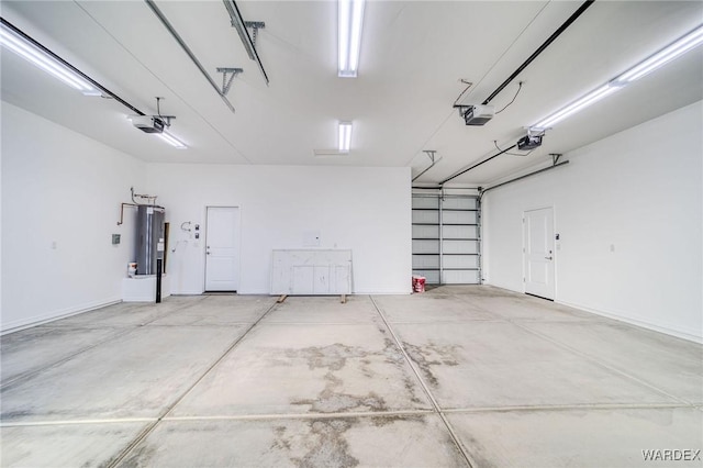 garage with a garage door opener, electric water heater, and baseboards