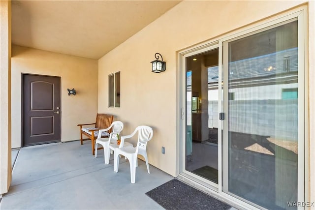 entrance to property with stucco siding