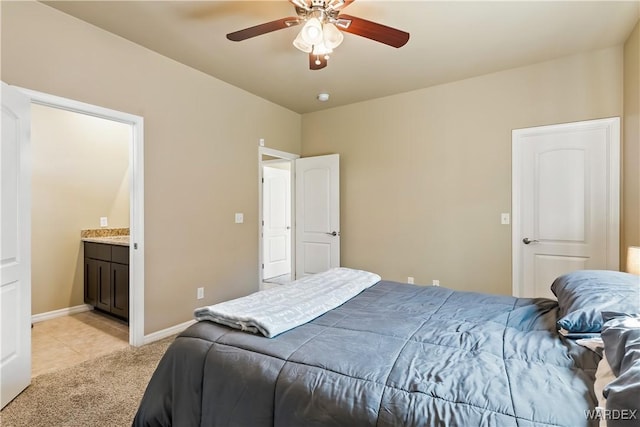 bedroom featuring ceiling fan, light colored carpet, baseboards, and connected bathroom