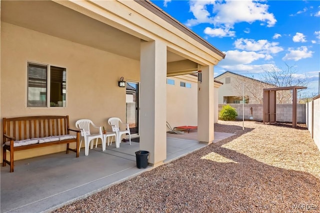 view of patio featuring fence