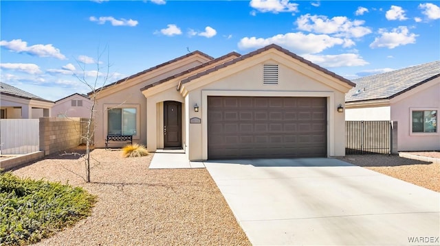 ranch-style house featuring stucco siding, a garage, driveway, and fence