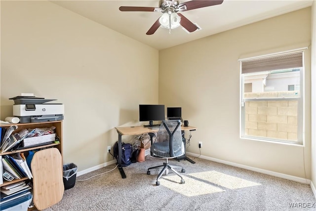 carpeted home office featuring ceiling fan and baseboards