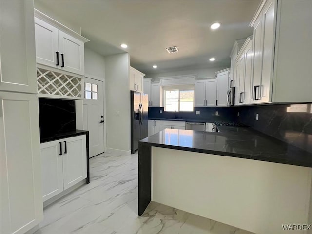 kitchen featuring marble finish floor, stainless steel appliances, recessed lighting, a sink, and a peninsula