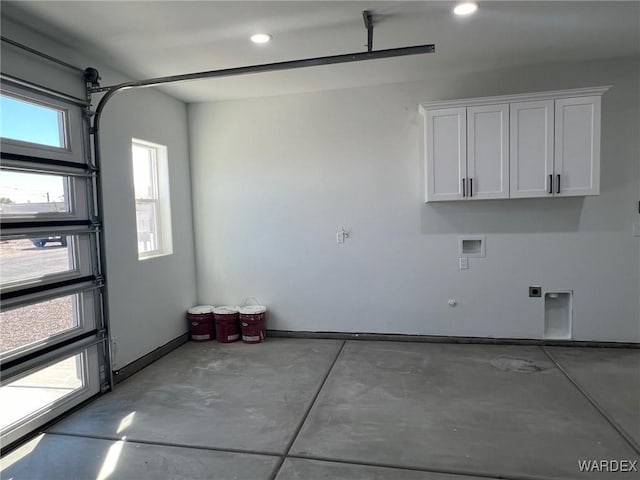 garage with recessed lighting and baseboards