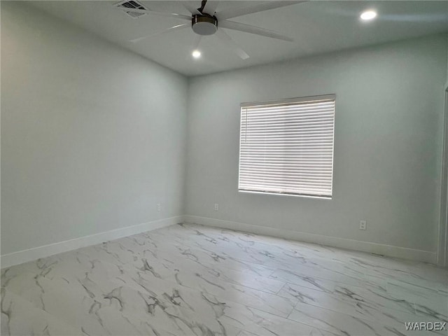 unfurnished room featuring marble finish floor, a ceiling fan, visible vents, and baseboards