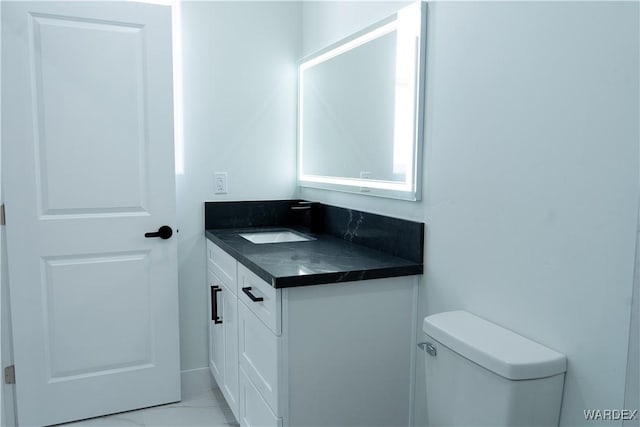 bathroom featuring toilet and vanity