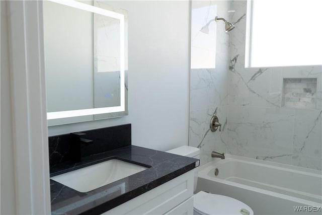 full bath with shower / bathing tub combination, vanity, and toilet