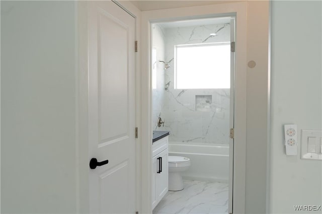 bathroom with marble finish floor, tub / shower combination, vanity, and toilet