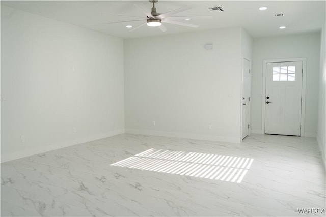 empty room featuring recessed lighting, marble finish floor, visible vents, and baseboards