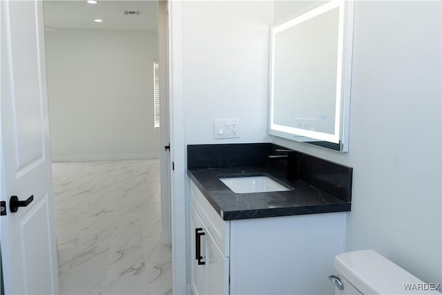 half bathroom featuring toilet, recessed lighting, visible vents, vanity, and marble finish floor