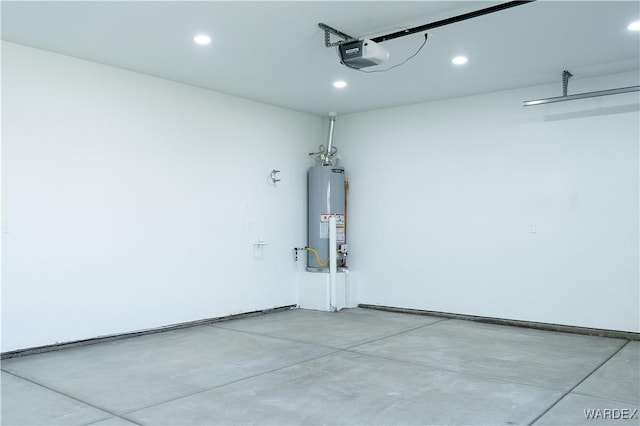 garage with a garage door opener, recessed lighting, and water heater