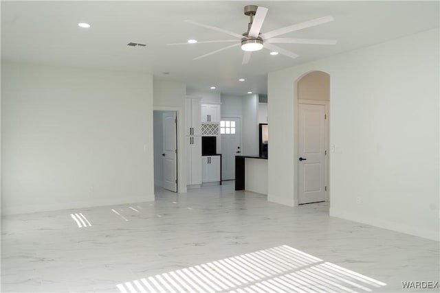 spare room with visible vents, arched walkways, a ceiling fan, marble finish floor, and recessed lighting