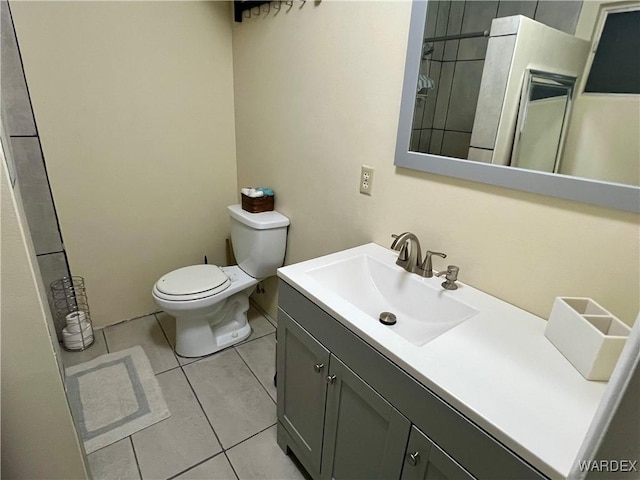 bathroom featuring toilet, tile patterned flooring, and vanity