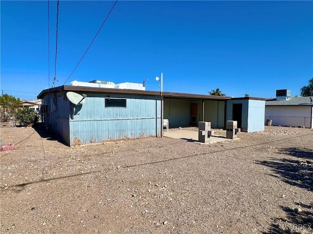 rear view of property featuring a patio area and cooling unit