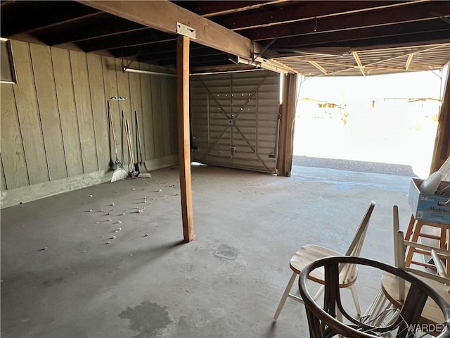 garage featuring wood walls