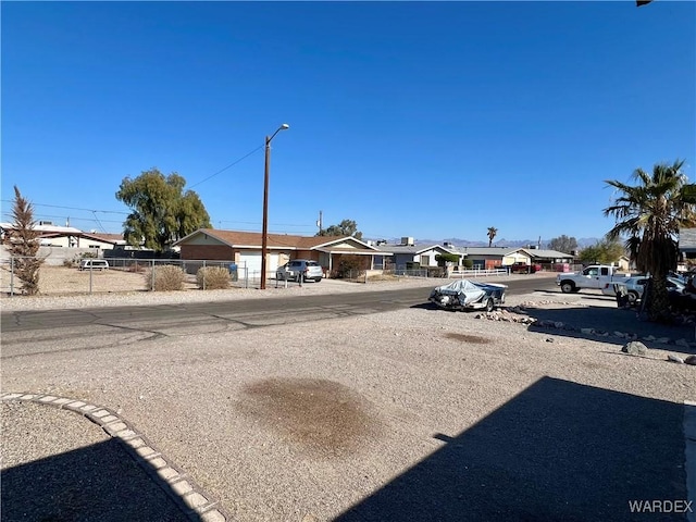 view of street featuring a residential view and street lights