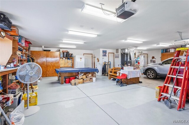 garage featuring a garage door opener and gas water heater