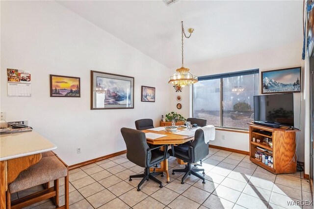 dining area featuring lofted ceiling, an inviting chandelier, baseboards, and light tile patterned flooring