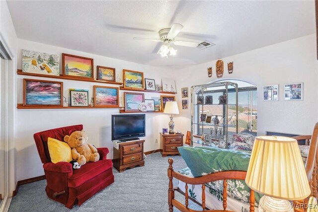 sitting room with carpet, visible vents, ceiling fan, and baseboards