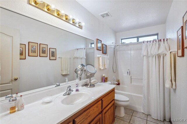 full bathroom with visible vents, toilet, shower / tub combo with curtain, tile patterned floors, and vanity