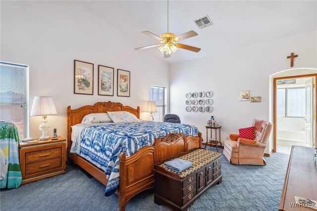 carpeted bedroom featuring visible vents, vaulted ceiling, and ceiling fan