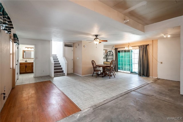 unfurnished dining area featuring ceiling fan and stairway