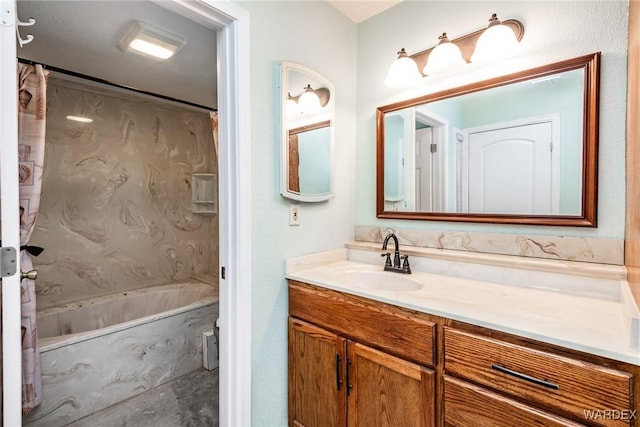 full bath featuring vanity and a combined bath / shower with marble appearance