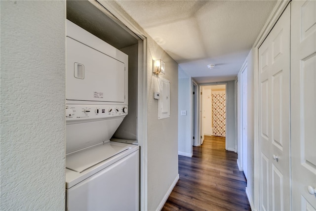 1800 Clubhouse Dr Unit H70, Bullhead City, AZ 86442 - laundry room with estacked washer and dryer, dark wood-type flooring, baseboards, a textured ceiling, and a textured wall