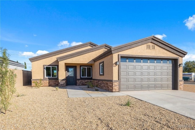 single story home featuring a garage, fence, stone siding, driveway, and stucco siding