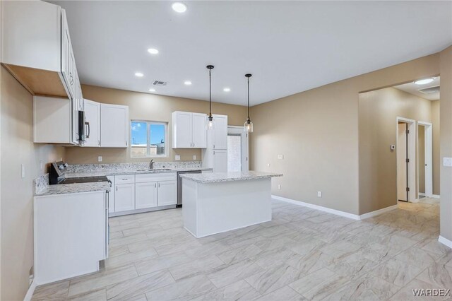 kitchen featuring visible vents, white cabinets, dishwasher, a center island, and a sink