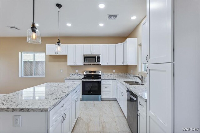 kitchen with marble finish floor, visible vents, appliances with stainless steel finishes, white cabinetry, and a sink