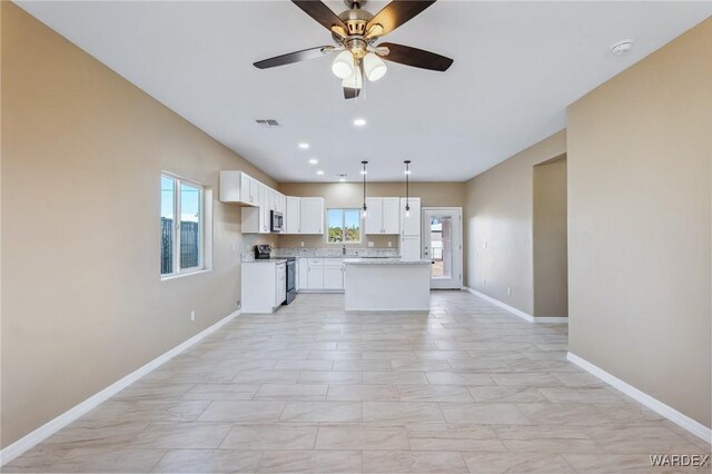 kitchen with visible vents, baseboards, appliances with stainless steel finishes, light countertops, and white cabinetry