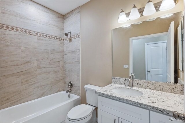 full bath featuring vanity, toilet, and bathing tub / shower combination