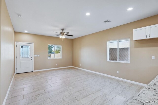 spare room with ceiling fan, visible vents, baseboards, and recessed lighting