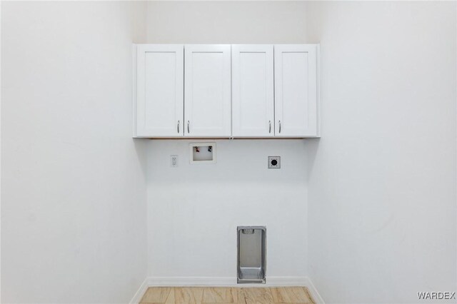 laundry room featuring cabinet space, hookup for a washing machine, baseboards, and hookup for an electric dryer