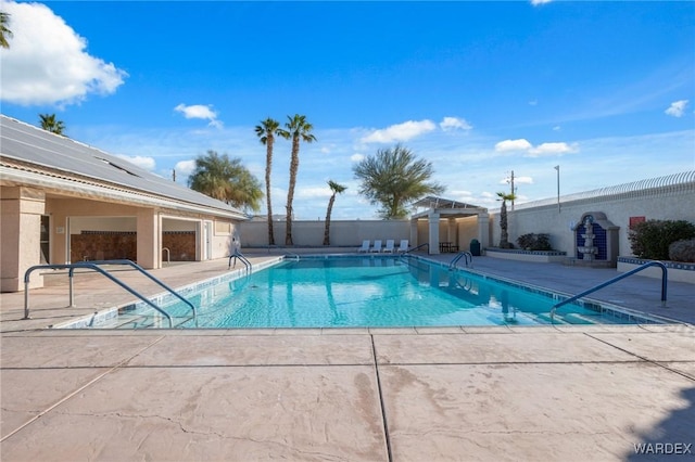 pool featuring a patio area and fence