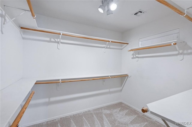 walk in closet with carpet floors and visible vents