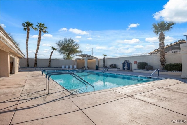 pool with a patio area and a fenced backyard