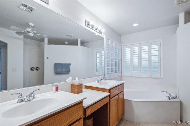 bathroom featuring a bath, visible vents, and a sink