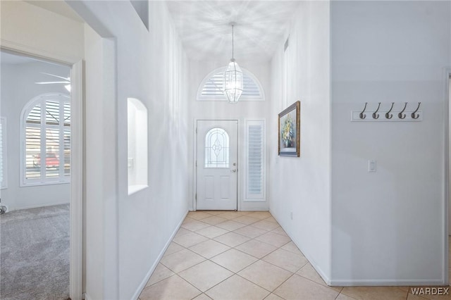 foyer entrance featuring a notable chandelier and light tile patterned flooring