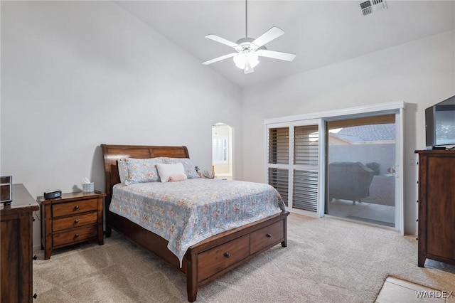 bedroom with light carpet, visible vents, arched walkways, ceiling fan, and access to exterior