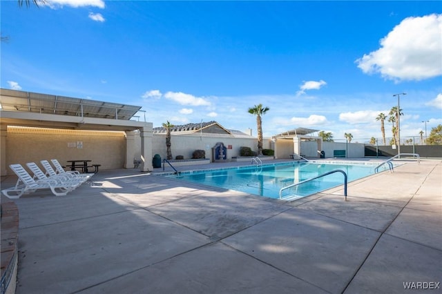 pool featuring a patio area and fence