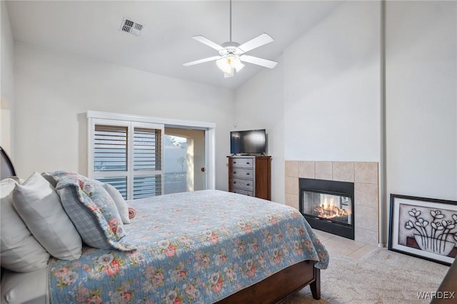 bedroom with lofted ceiling, visible vents, a fireplace, and ceiling fan