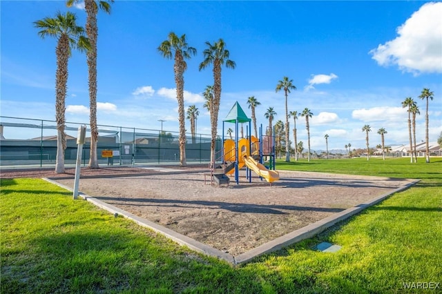 communal playground with a yard and fence