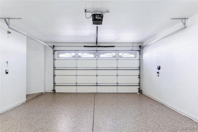 garage with a garage door opener and baseboards