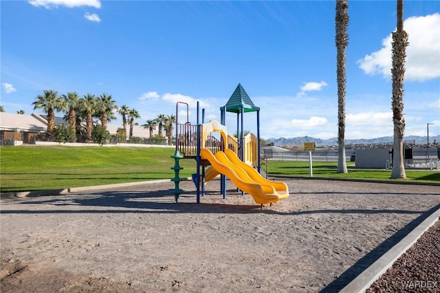 communal playground featuring a lawn