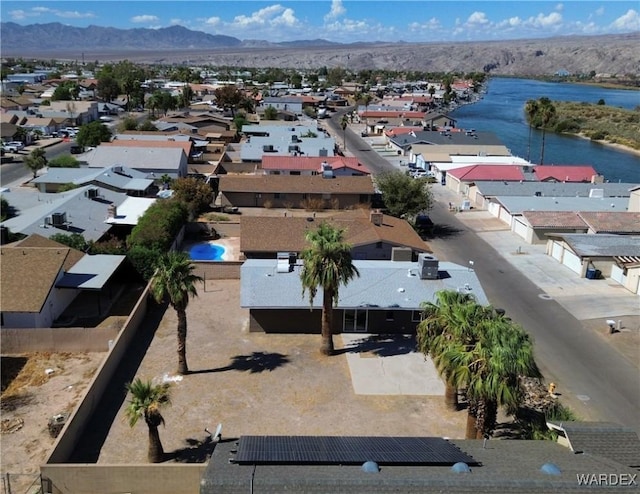 drone / aerial view with a residential view and a water and mountain view